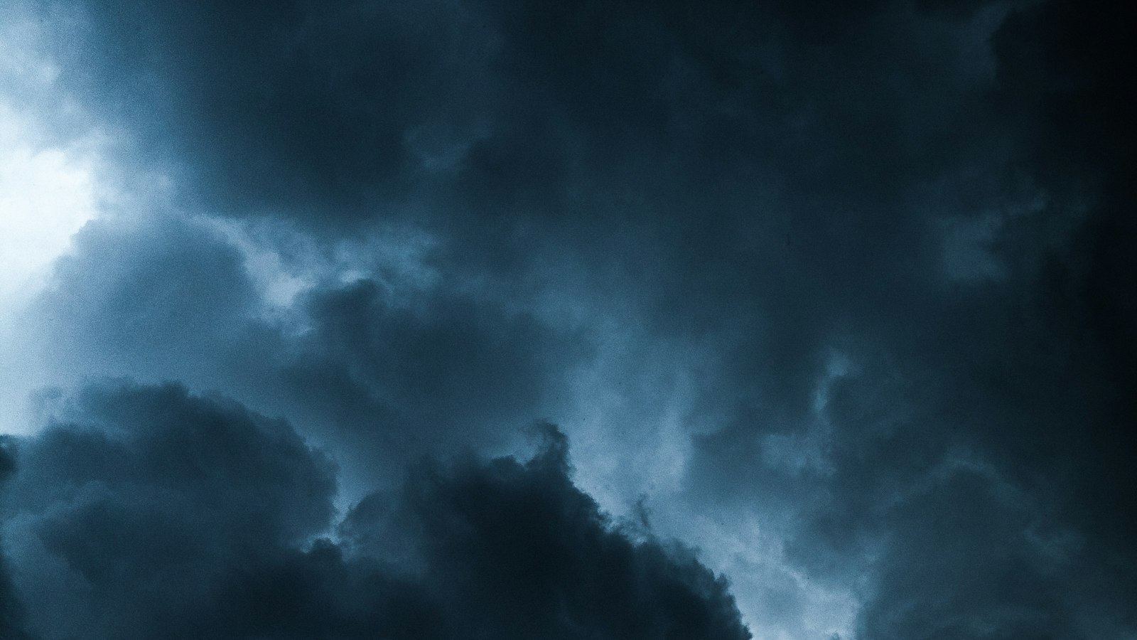 Dark storm clouds with light breaking through