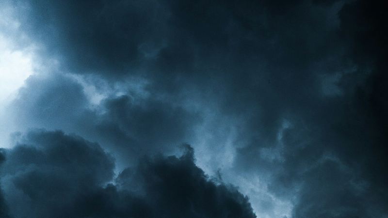 Dark storm clouds with light breaking through