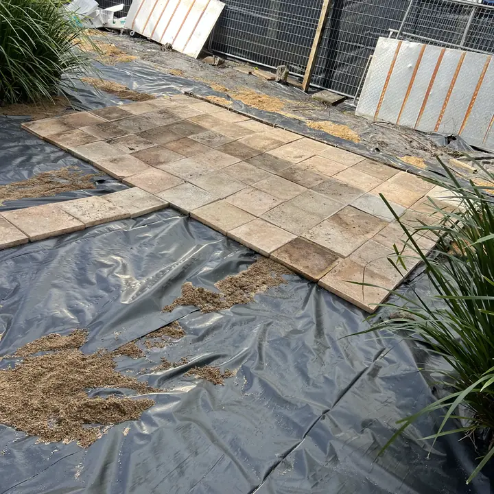 After: overgrown side yard cut back to the ground and weed-matted, Noosa